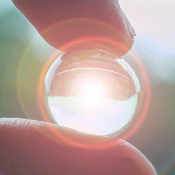 clarity Fingers Holding a Glowing Marble